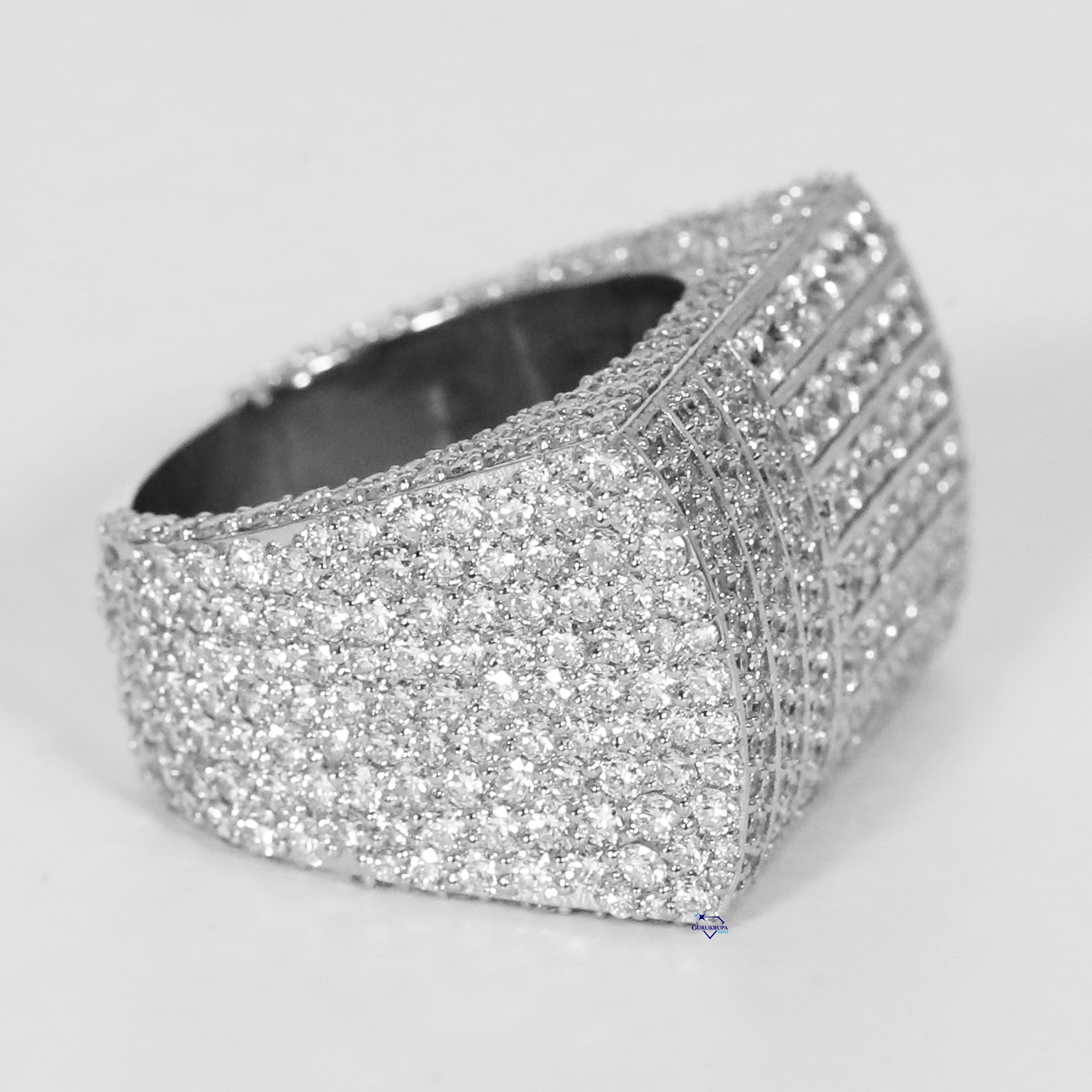 Step into opulence with hip hop ring crafted in 14 kt white gold and featuring moissanite round cut diamond with vvs clarity