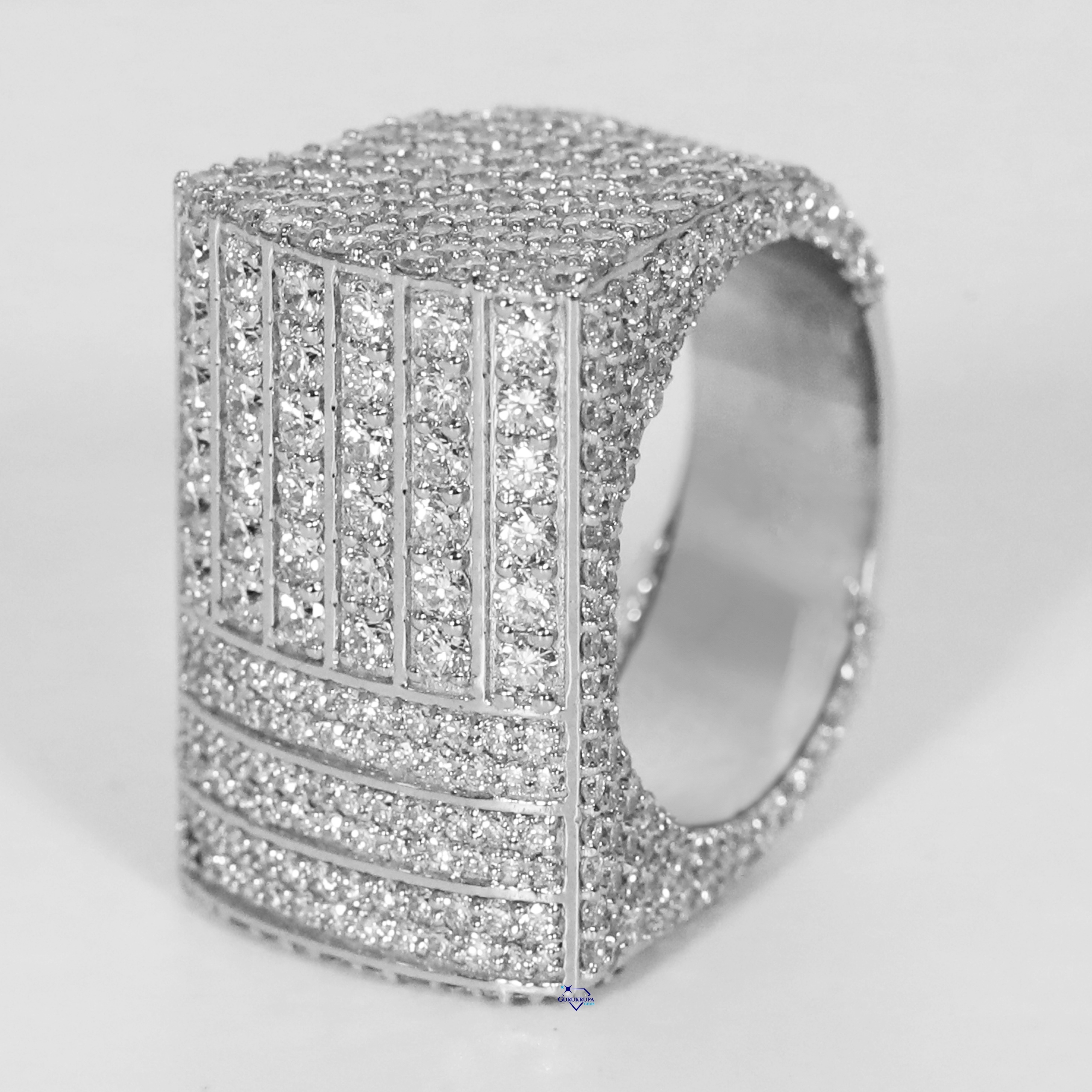 Step into opulence with hip hop ring crafted in 14 kt white gold and featuring moissanite round cut diamond with vvs clarity