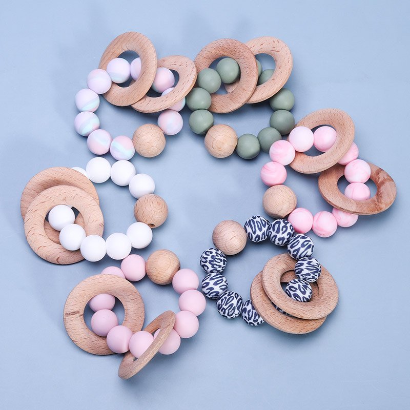 A New Design Sensory Baby Teething Toys Soft Bpa Free Food Grade Christmas Rainbow Wooden Ring Teether Baby Teether