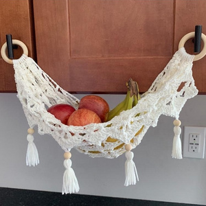 Handcrafted cotton macrame fruit hammocks with gold metal hooks from Vietnam