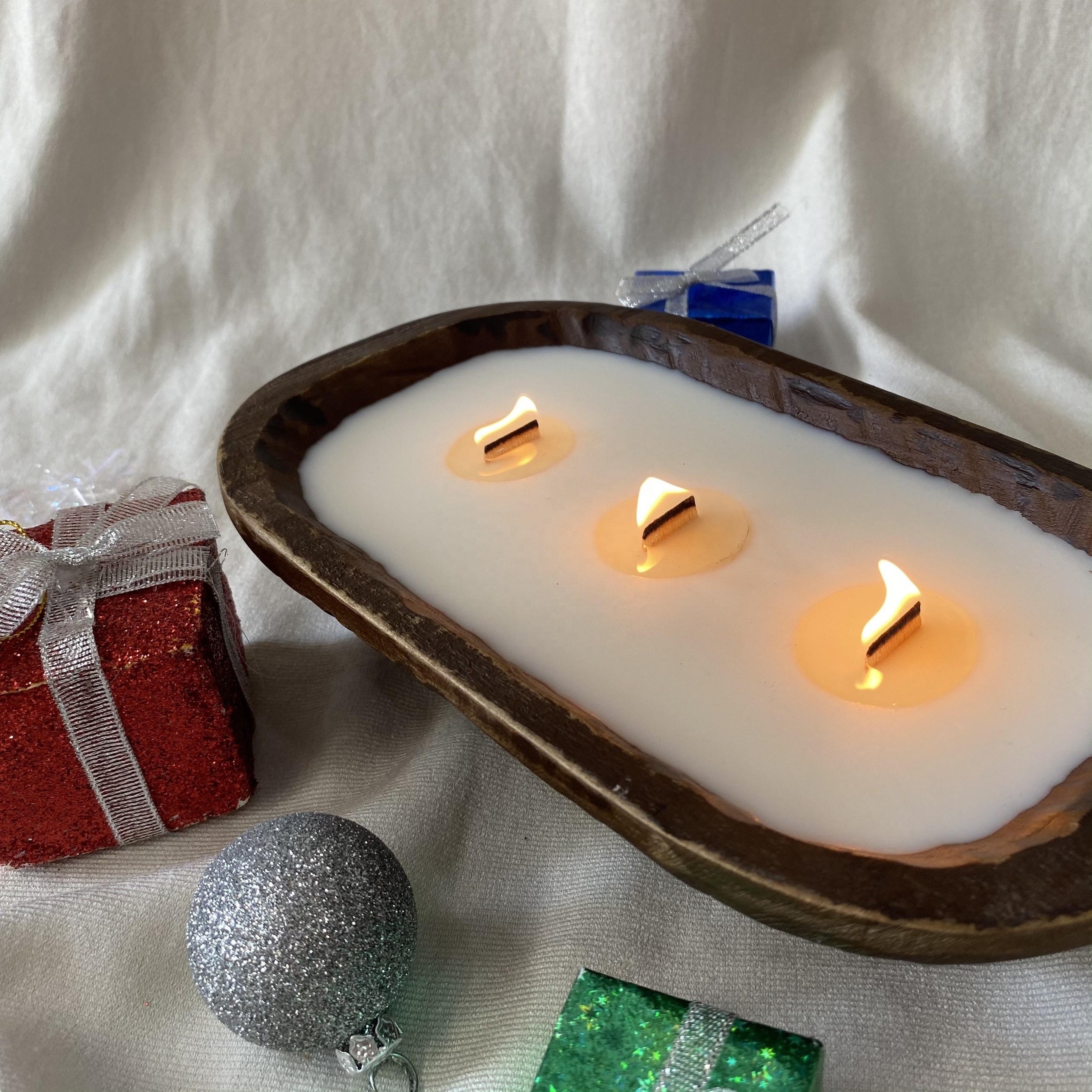 Hand-poured vanilla scented candles in hearted shape wooden bowls from Vietnam