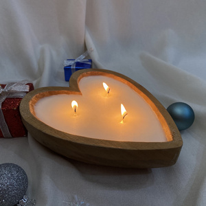 Hand-poured vanilla scented candles in hearted shape wooden bowls from Vietnam