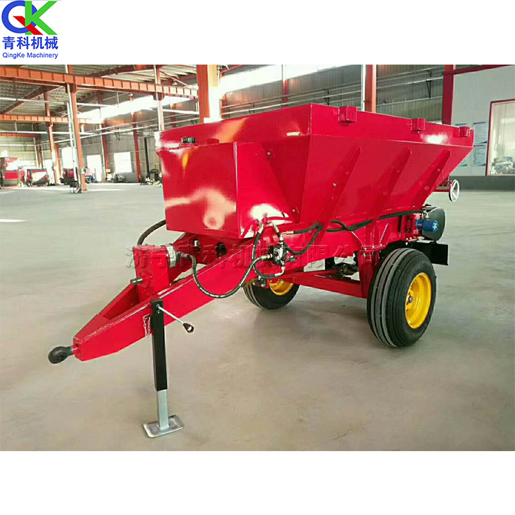 Tractor pulling farmyard manure spreading equipment 2 cubic agricultural fertilizer thrower