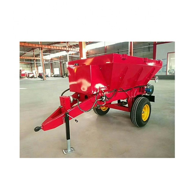 Tractor pulling farmyard manure spreading equipment 2 cubic agricultural fertilizer thrower