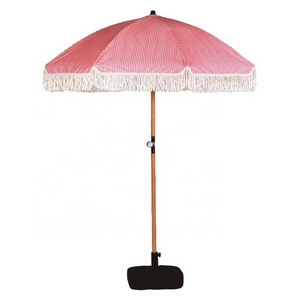 Good quality pagoda parasol with wooden pole and cotton fringe beach umbrella