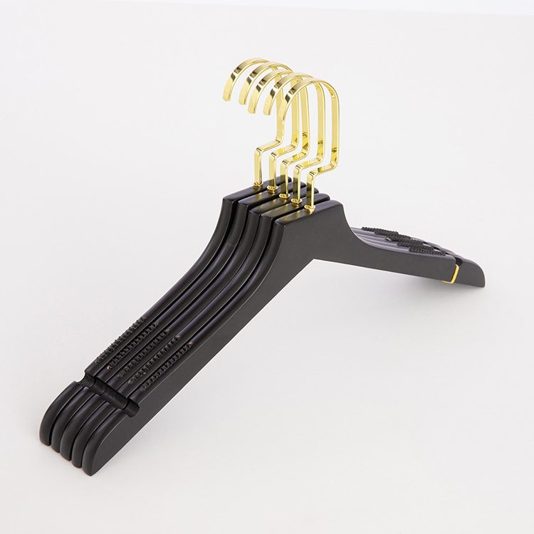 Luxury clothes shops wooden coat hangers in black with gold metal for children