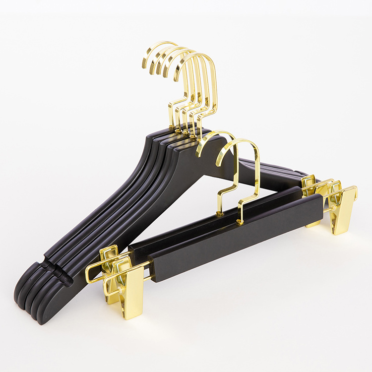 Luxury clothes shops wooden coat hangers in black with gold metal for children