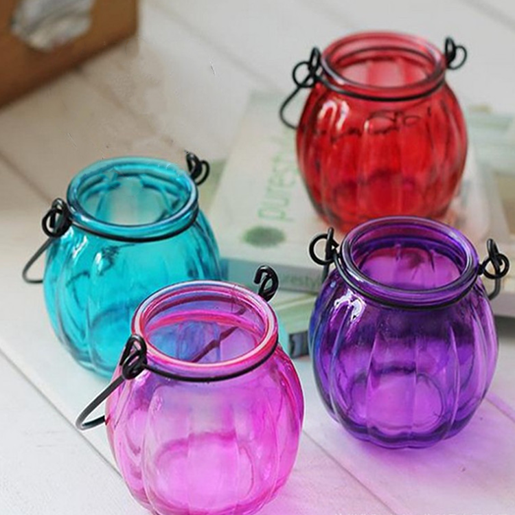 Pumpkin shaped colored glass candle holder with carrying handle