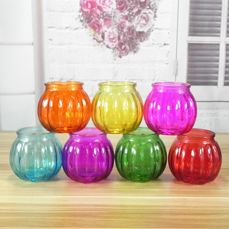 Pumpkin shaped colored glass candle holder with carrying handle