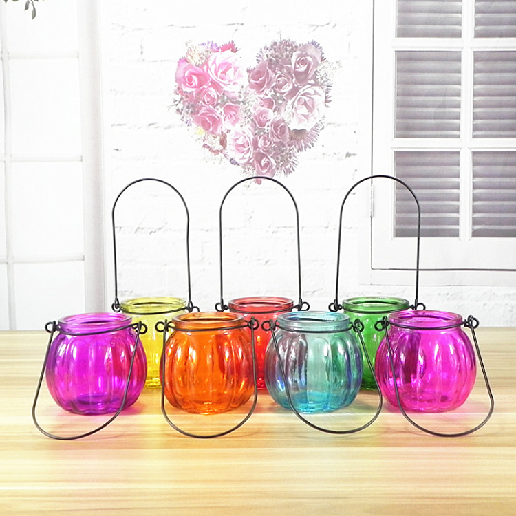 Pumpkin shaped colored glass candle holder with carrying handle