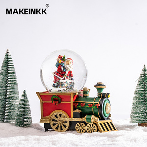 High quality Battery Operated Led Glittering Water Spinning Train Shape Couple Dancing Christmas Decoration Snow Globe