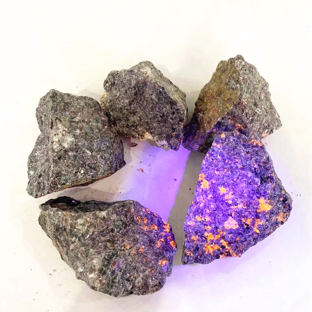 Natural rough crystal healing stone rocks under ultraviolet light flash yooperlite raw stone