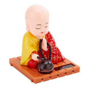 Shaking head car decoration small monk Buddha statue creative doll home solar small monk car decoration blue red yellow