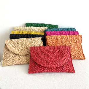 Niyang wholesale women handmade beach travel shopping corn husk pompoms tassel handbags summer straw clutch bag