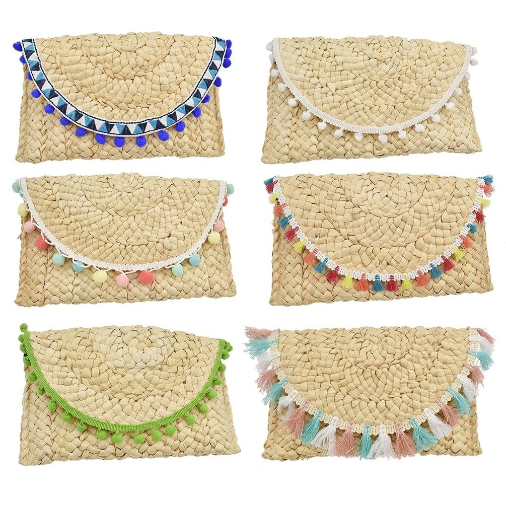 Niyang wholesale women handmade beach travel shopping corn husk pompoms tassel handbags summer straw clutch bag