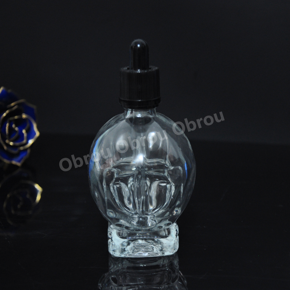 Wholesale 30ml perfume bottle essential oil glass skull bottle with child proof dropper