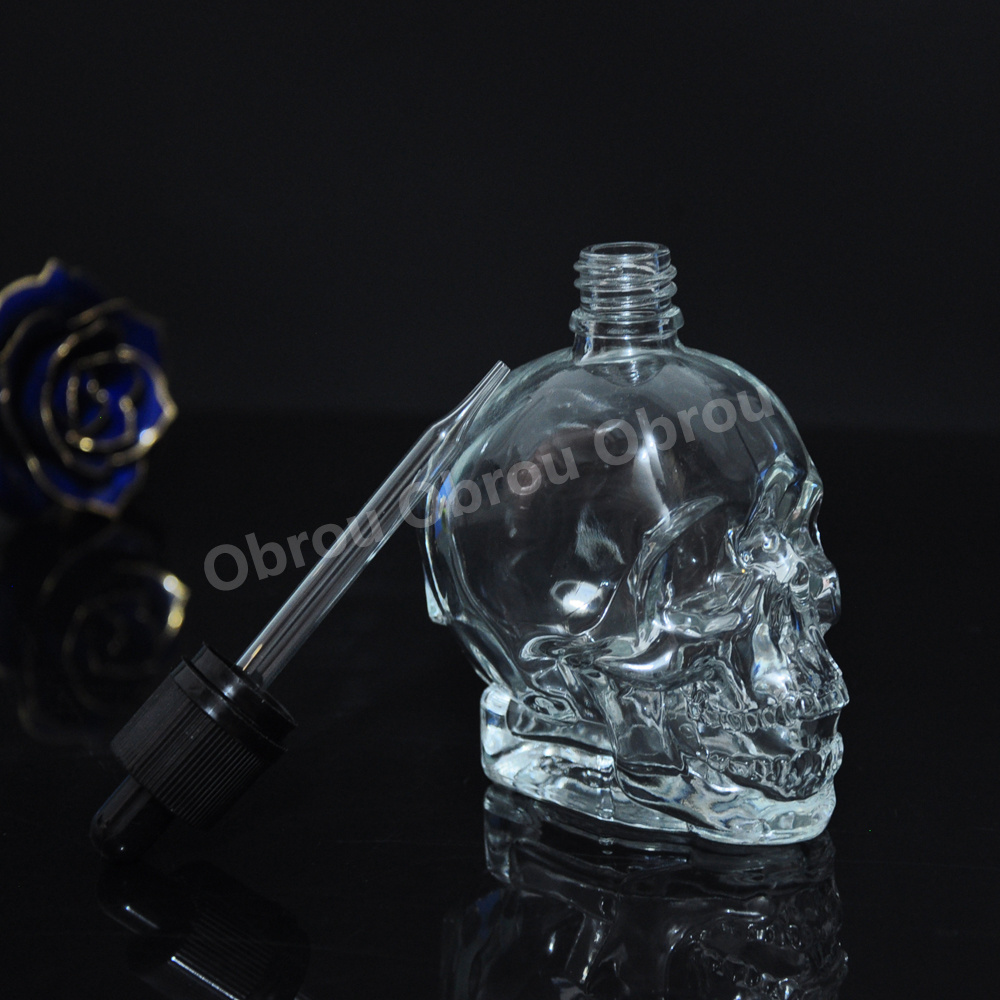 Wholesale 30ml perfume bottle essential oil glass skull bottle with child proof dropper