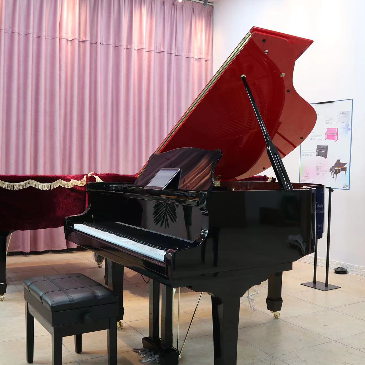 Grand piano with red top  The hotel plays the piano automatically  Six foot grand piano