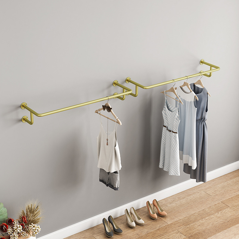 Metal Golden Clothing Display Rack On Wall Side Hanger In Modern Boutique Clothing Store