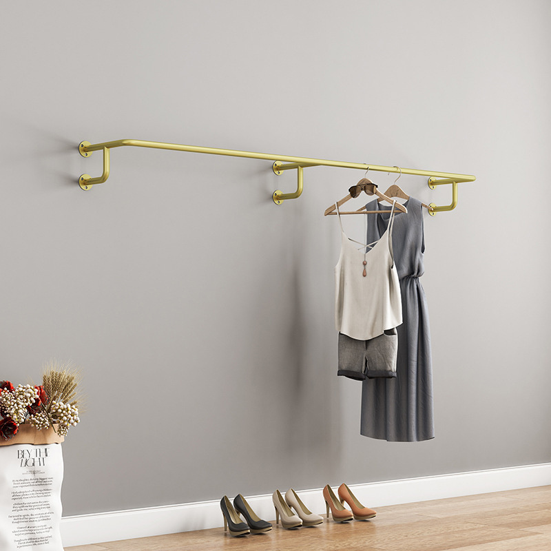 Metal Golden Clothing Display Rack On Wall Side Hanger In Modern Boutique Clothing Store