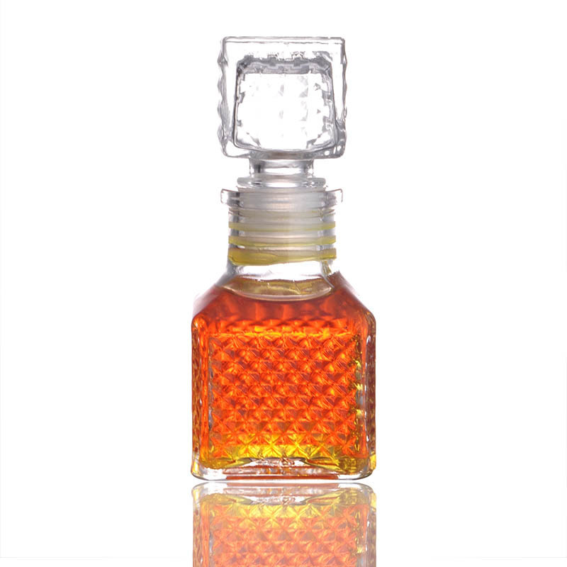 Customize Luxury Mini Liquor Bottle 50ml 100ml Embossed Glass Wine Container With Airtight Stopper Small Decanter