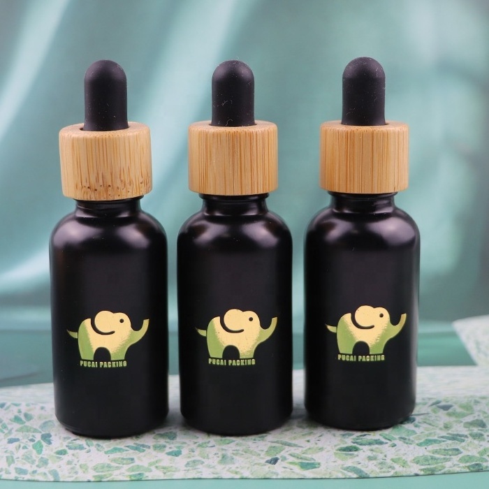 empty 30 ml 1 oz cosmetic cuticle hair essential oil bottles 30ml frosted black glass dropper bottle with bamboo lid top