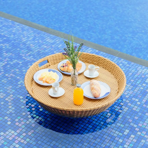 Madona round floating tray made of rattan frame and woven rattan with a natural brown finish.