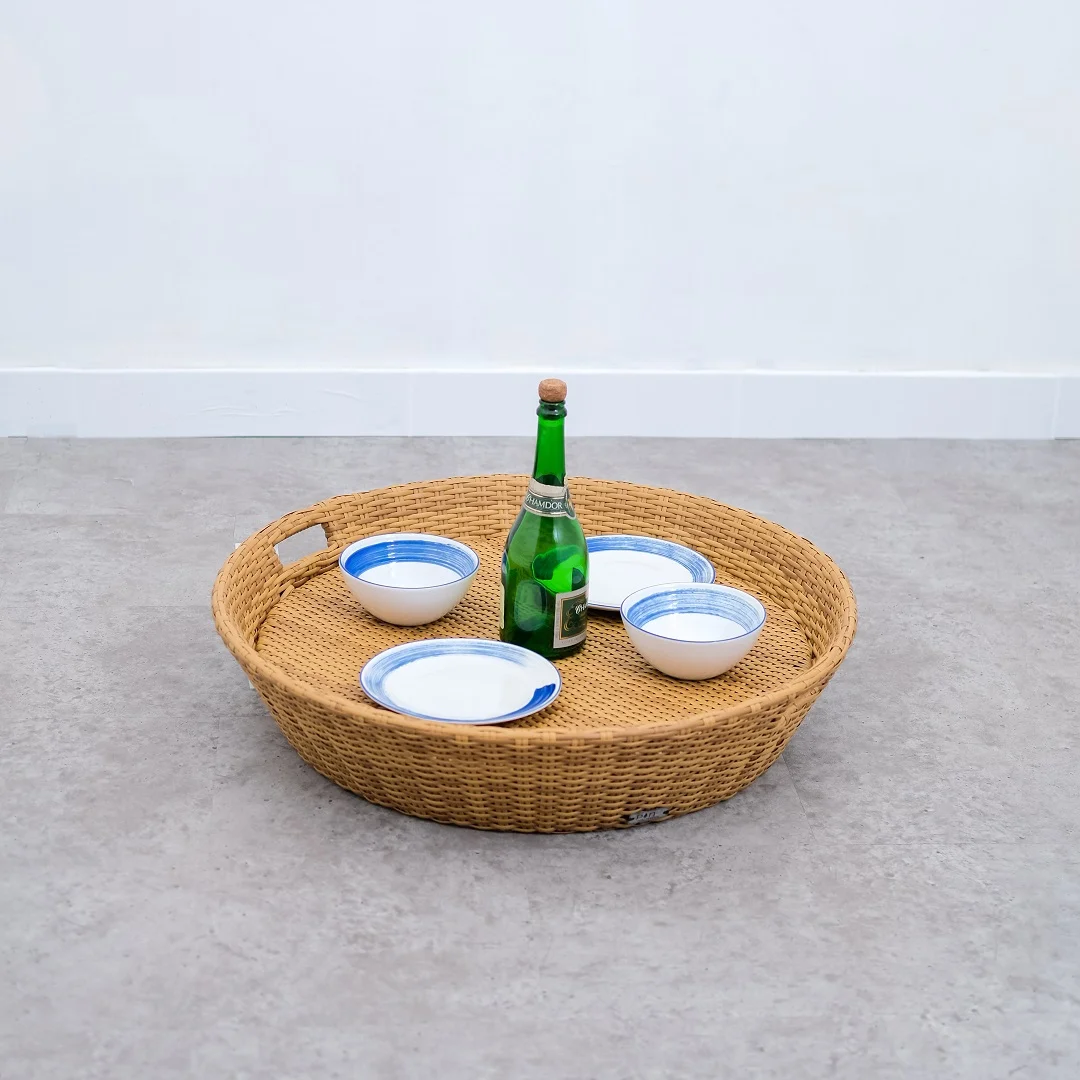 Madona round floating tray made of rattan frame and woven rattan with a natural brown finish.