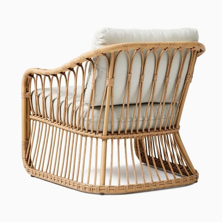 Lusy rattan patio chair with wicker rattan and thick cushions.