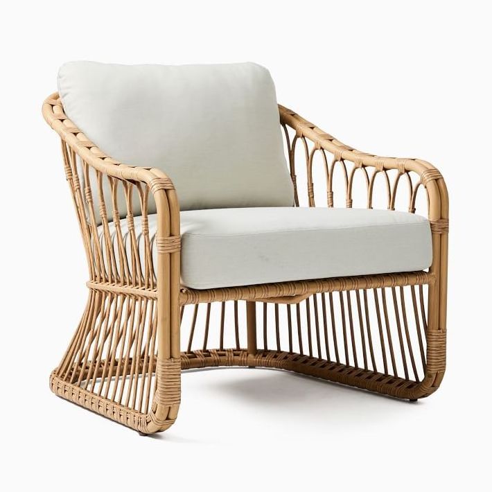 Lusy rattan patio chair with wicker rattan and thick cushions.