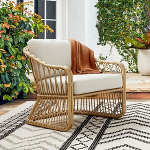 Lusy rattan patio chair with wicker rattan and thick cushions.