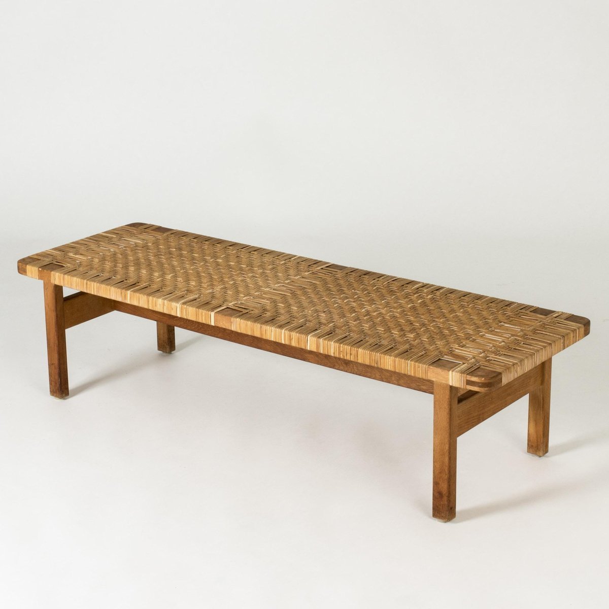 Aquata garden bench from solid teak wood and woven rattan with a natural finish.