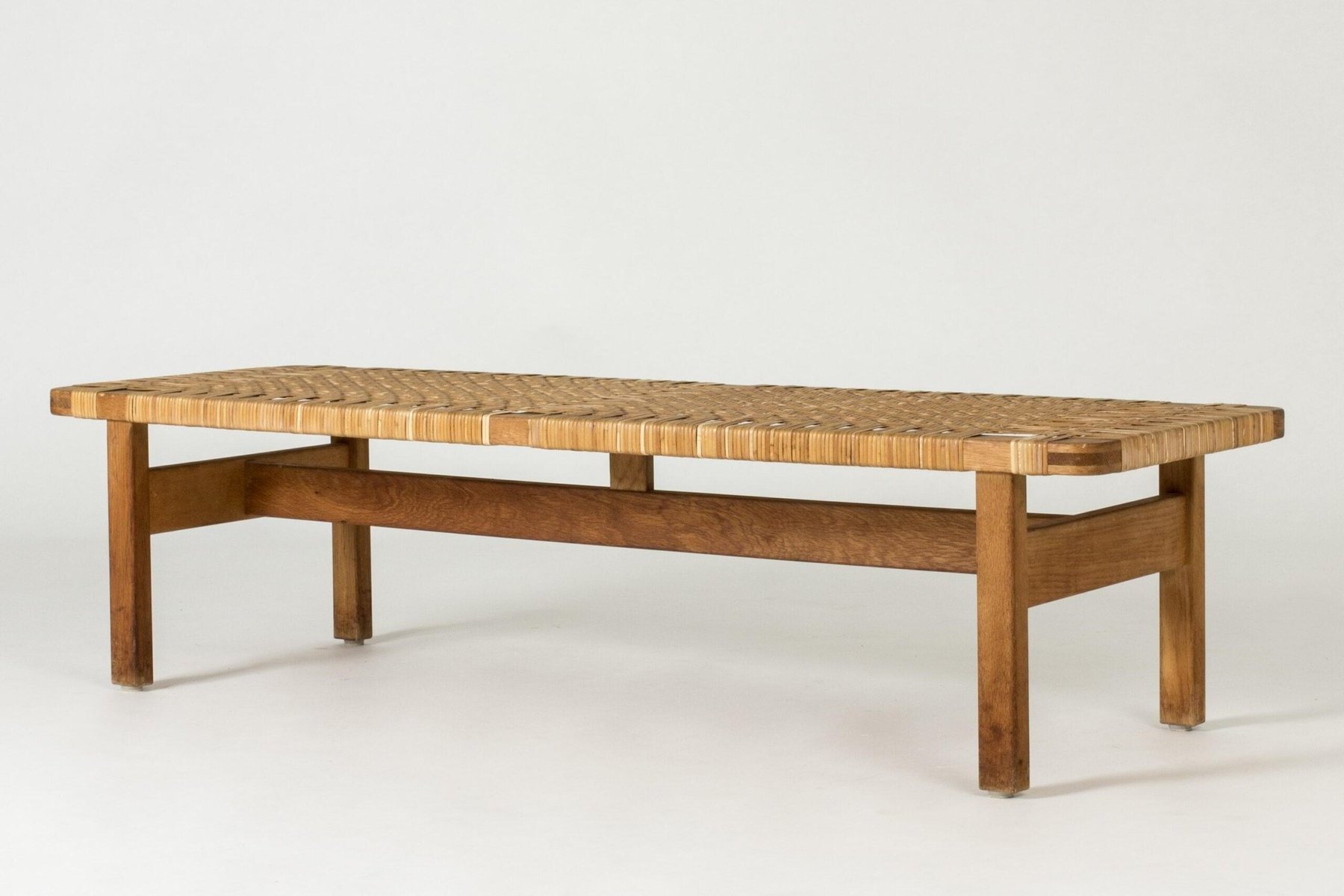 Aquata garden bench from solid teak wood and woven rattan with a natural finish.