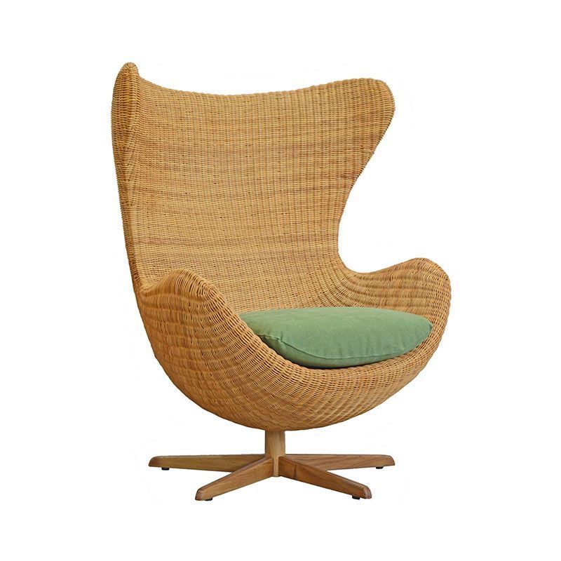 Bwuana egg lounge chair made from rattan and solid teak wood legs with natural oil finish for indoor and outdoor.