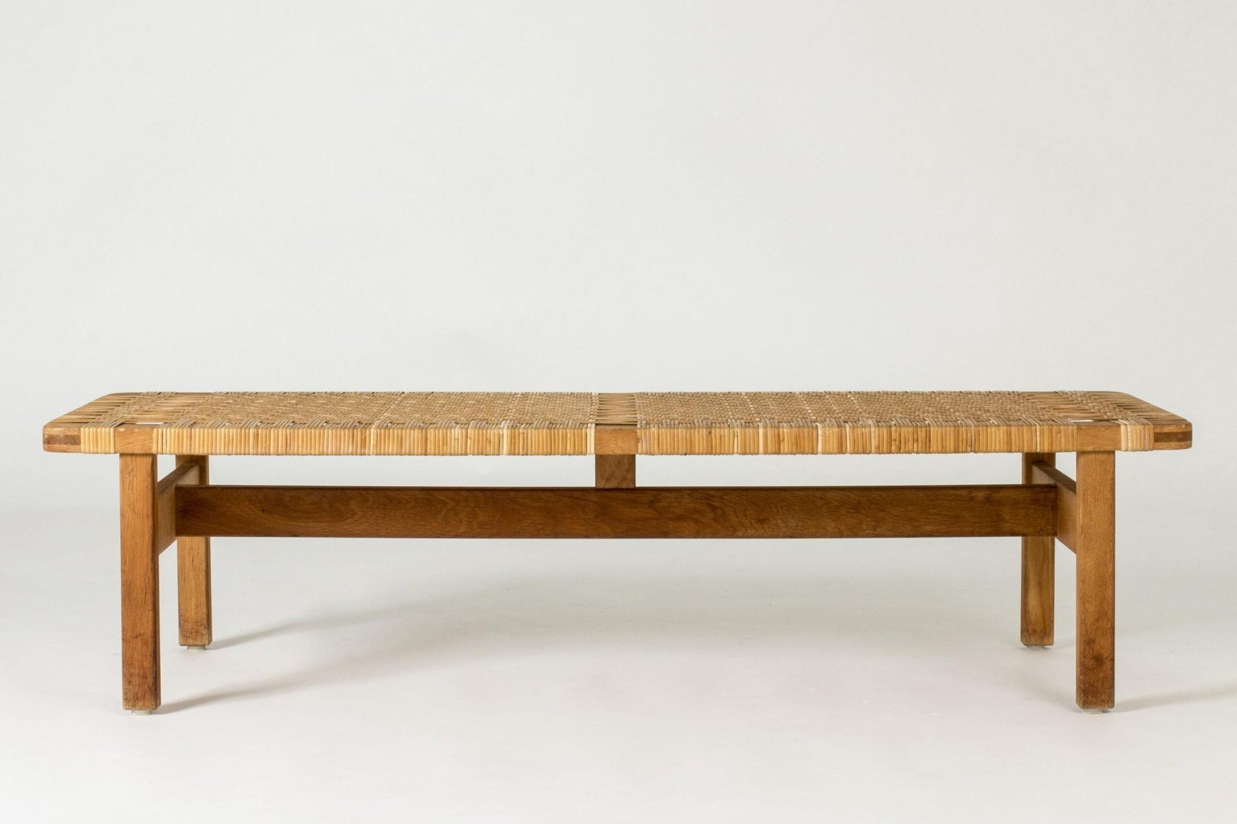 Aquata garden bench from solid teak wood and woven rattan with a natural finish.