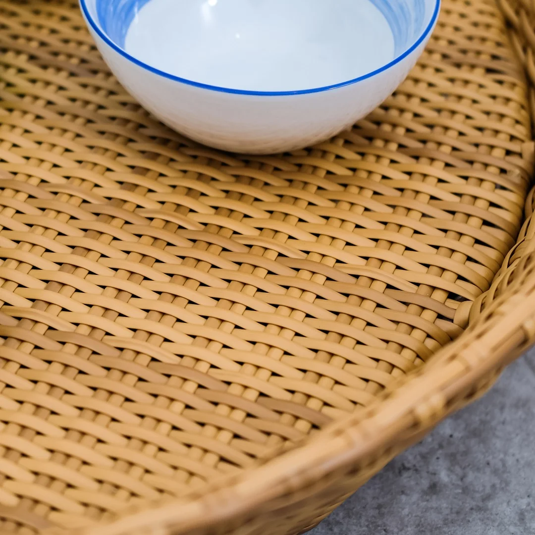 Madona round floating tray made of rattan frame and woven rattan with a natural brown finish.