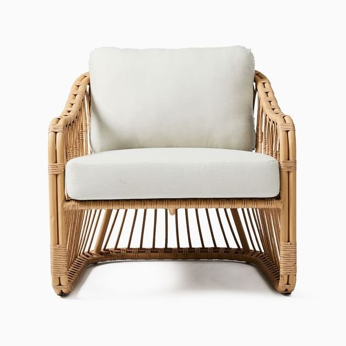 Lusy rattan patio chair with wicker rattan and thick cushions.