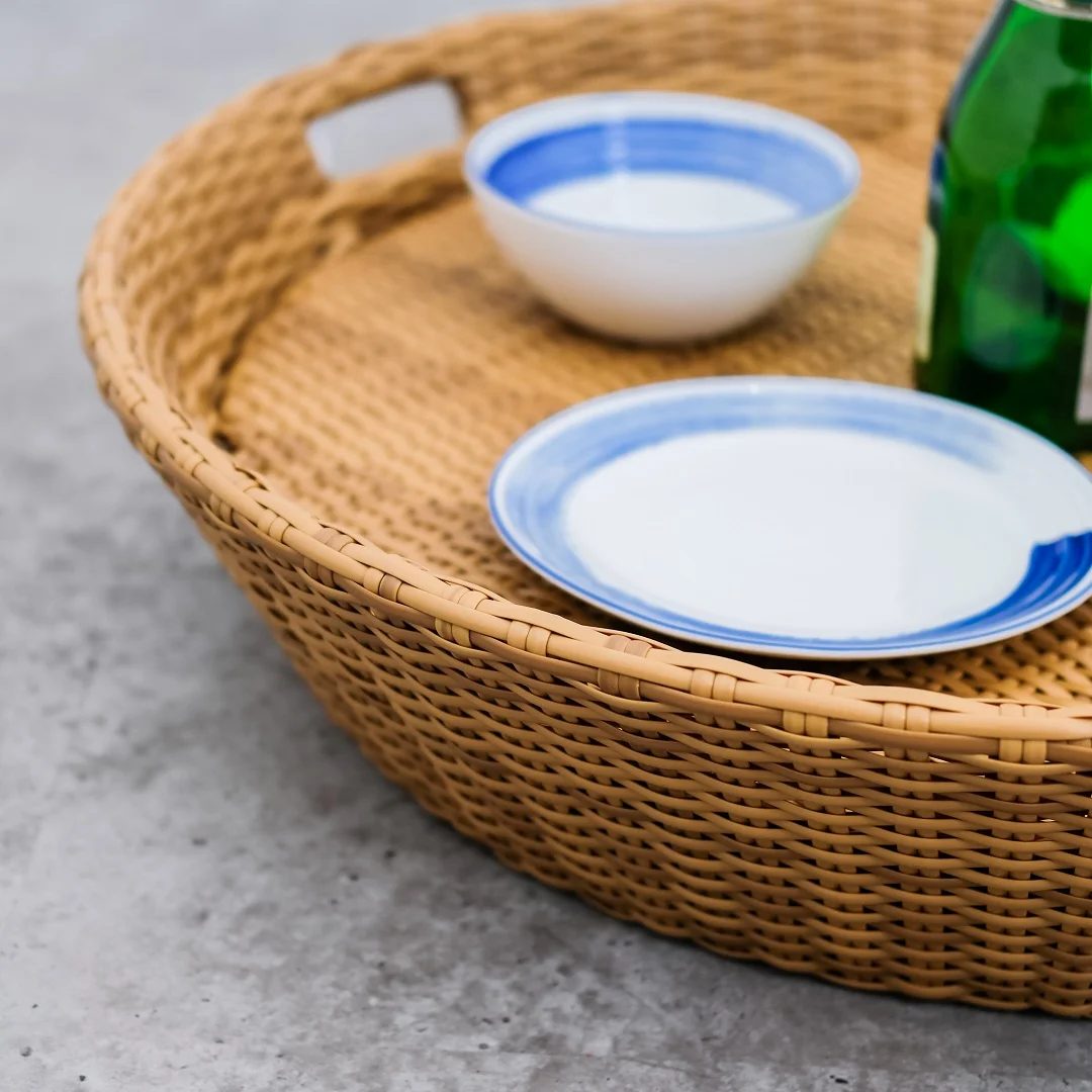 Madona round floating tray made of rattan frame and woven rattan with a natural brown finish.