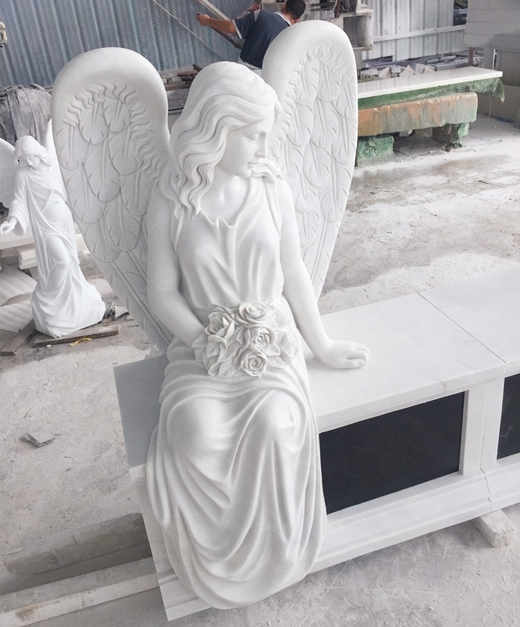 Marble double headstone with two sitting angel statues