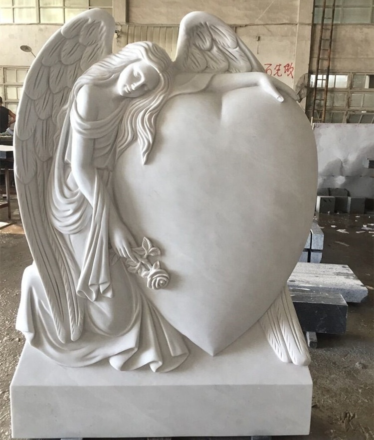 Marble double headstone with two sitting angel statues