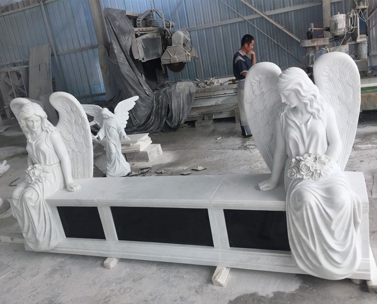 Marble double headstone with two sitting angel statues