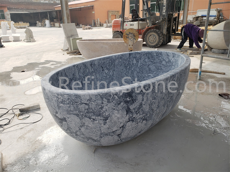 Polished black marble bathtub and hand carved stone bathtub