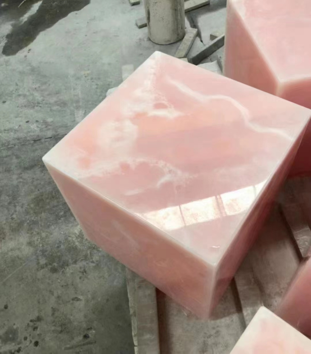 Transparent pink onyx cube plinth table