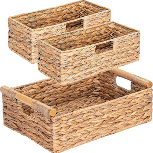 Natural wicker storage basket with wooden handle to store 3 bathroom baskets for home use