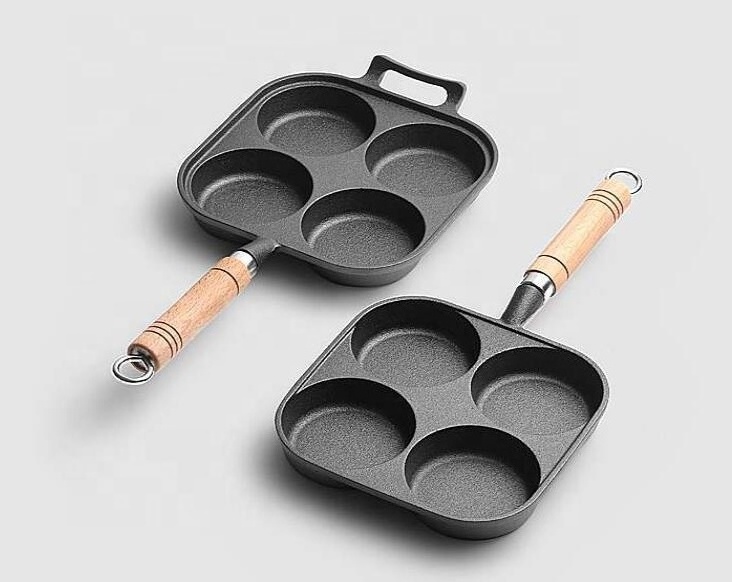 Four hole cast iron frying pan with wooden handle for cooking egg and hamburger