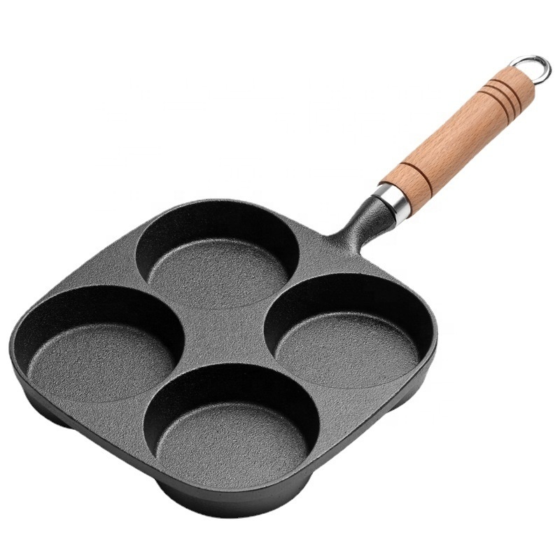 Four hole cast iron frying pan with wooden handle for cooking egg and hamburger