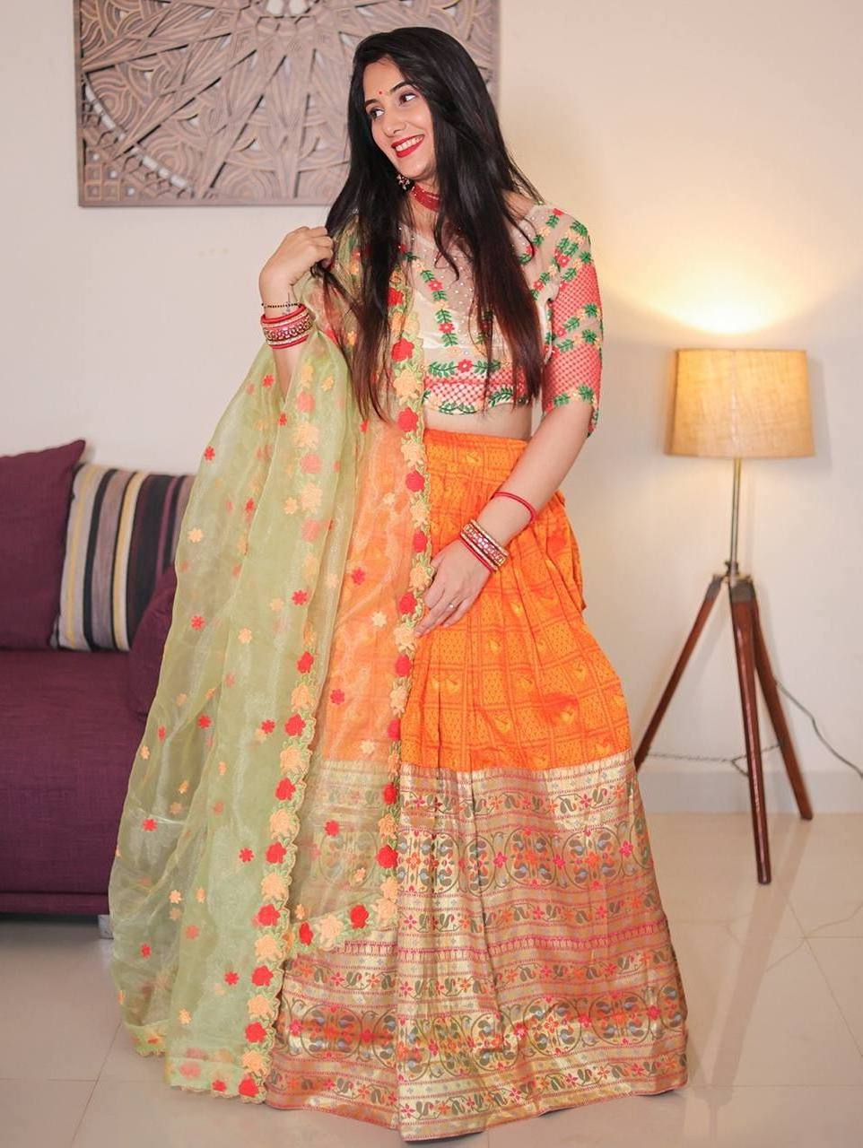 A jacquard orange lehenga with thread Embroidery work and handwork blouse with a beautiful organza dupatta