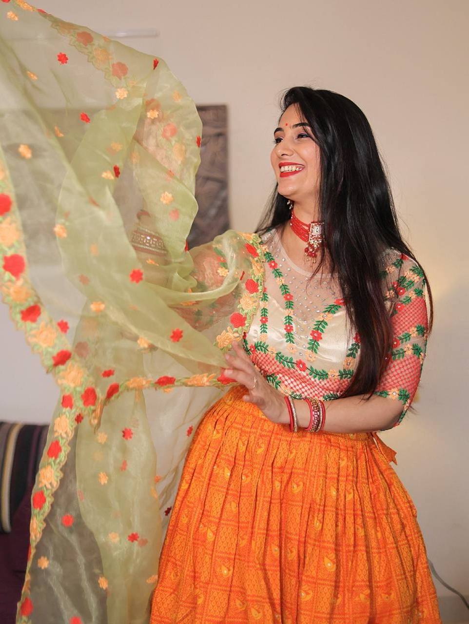 A jacquard orange lehenga with thread Embroidery work and handwork blouse with a beautiful organza dupatta