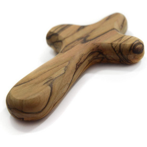 Hold an olive wood adsorption cross in delicate prayer olive wood comfort cross