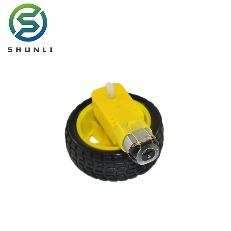 Yellow dc gear motor with plastic wheels of toy car